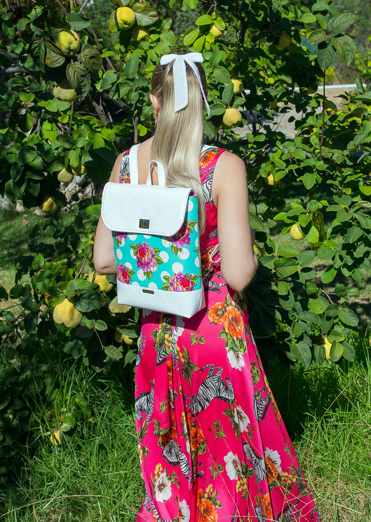 Bonn Backpack PDF sewing pattern in Tula Pink dripping roses fabric worn in the garden.