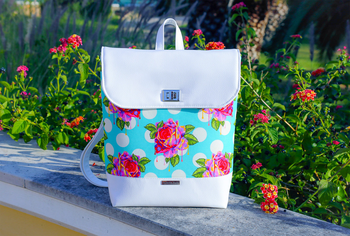 Bonn Backpack Pattern in Tula Pink fabric and white vinyl.